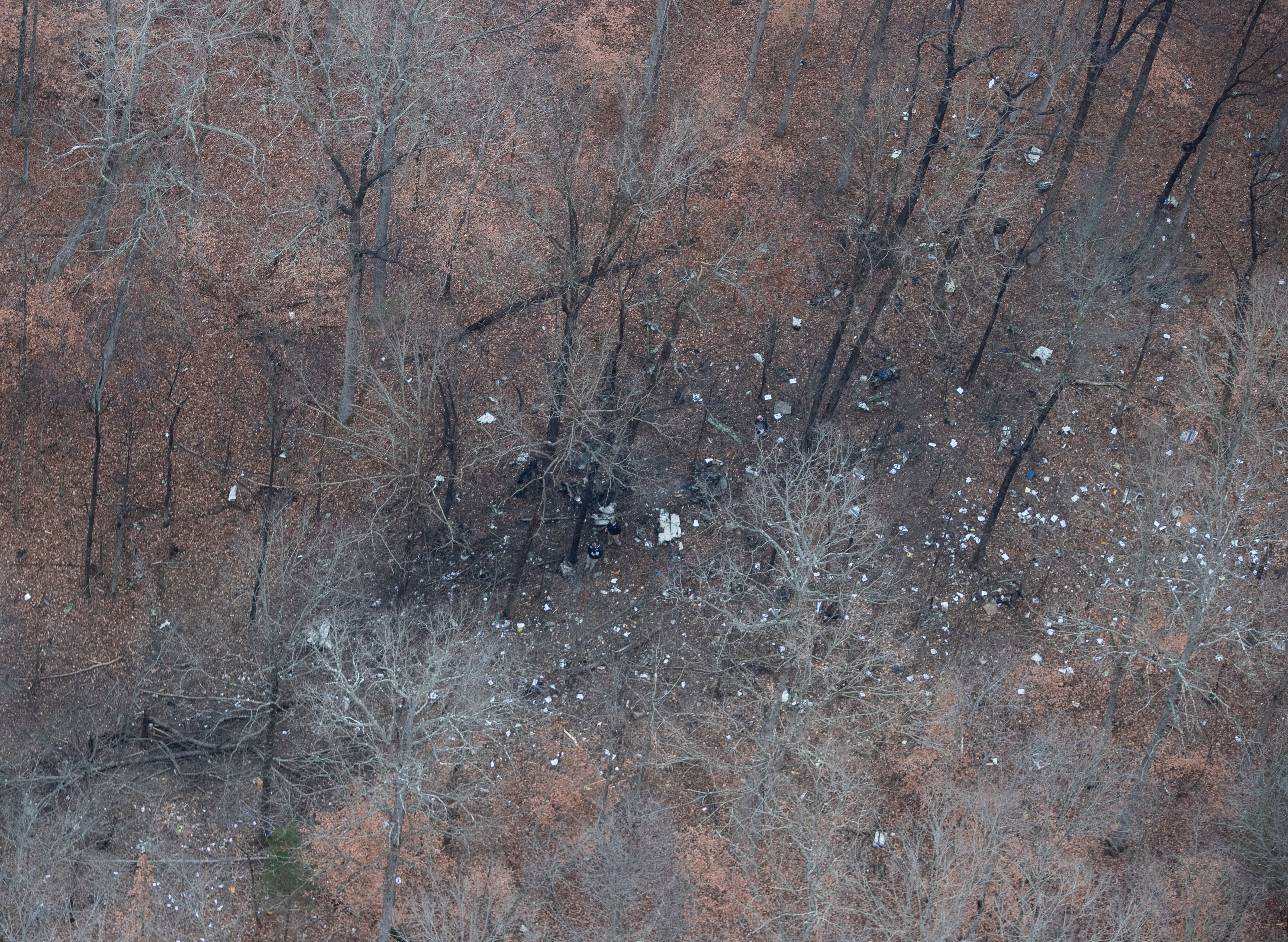 Rescue workers sort through the wreckage of a small plane that crashed in a wooded area near Memphis Indiana following a takeoff from the Clark County Airport. Nov. 30, 2018.